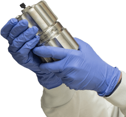 Gloved hands holding small metal cylindrical container