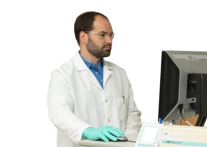 Scientist in lab coat working at computer desk