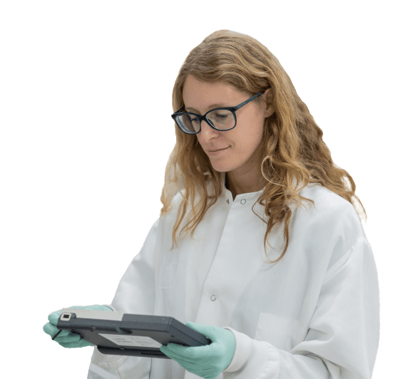 Scientist in lab coat and gloves working on tablet
